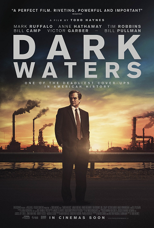 Poster image for film, showing a man in corporate attire against a backdrop of a river, and a factory with industrial smoke-stacks belching black clouds